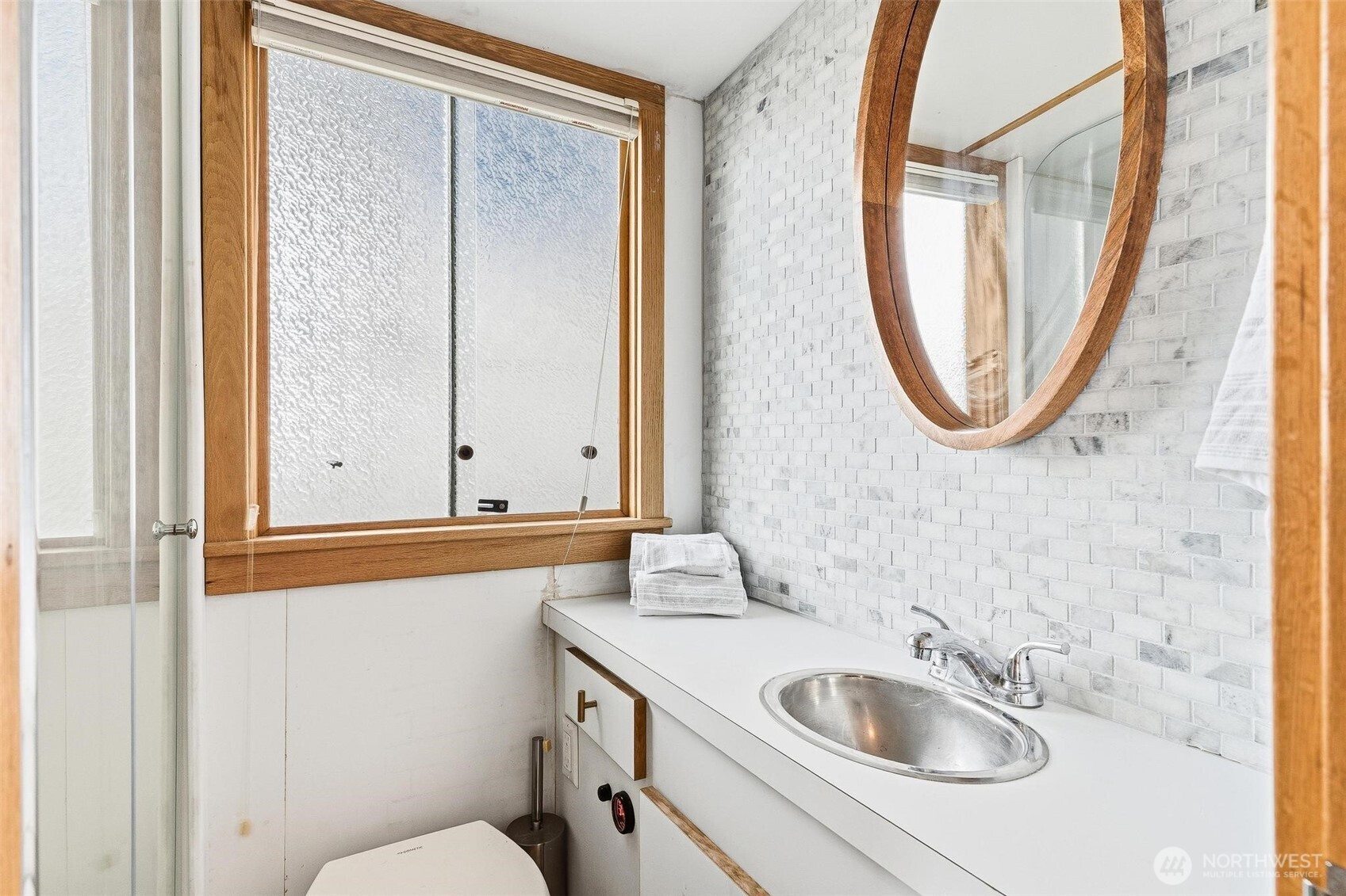 2401 North Northlake Way Seattle, WA 98103 - Photo 6 of 25 a bathroom with a sink and a mirror