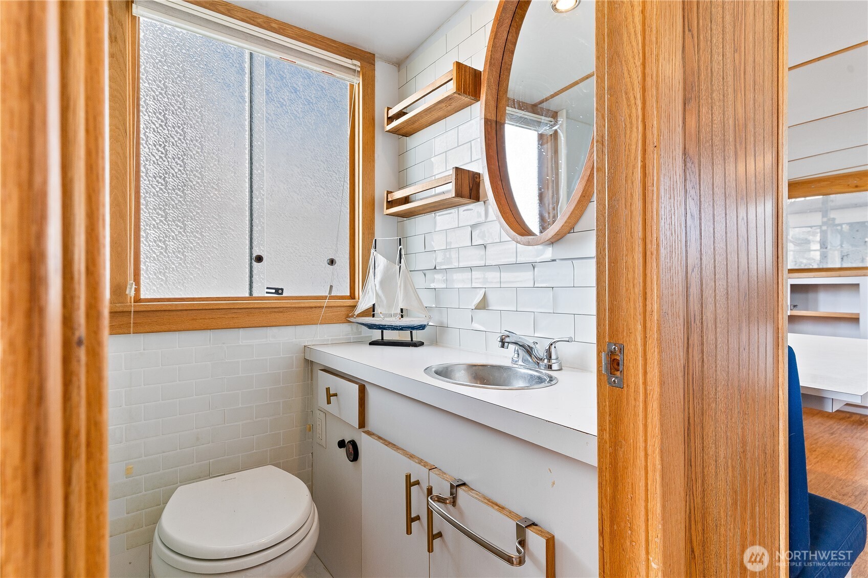 2401 North Northlake Way Seattle, WA 98103 - Photo 7 of 32 a bathroom with a sink a toilet and a mirror