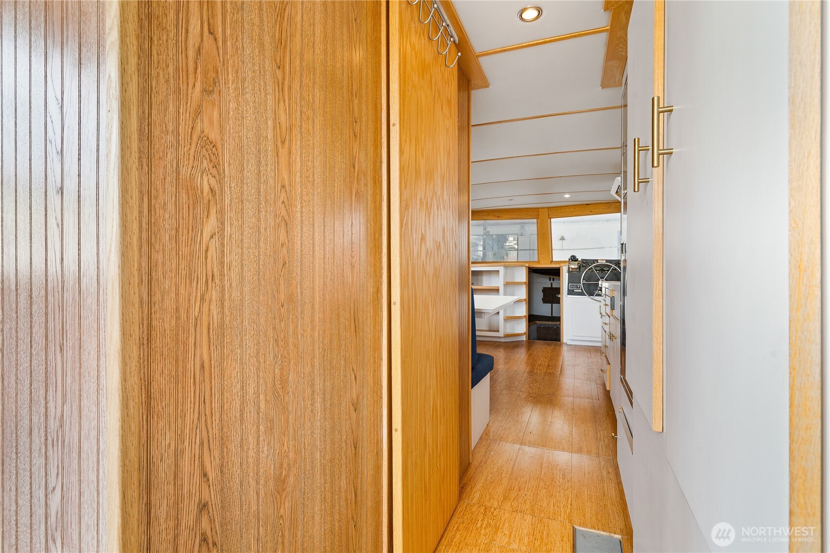2401 North Northlake Way Seattle, WA 98103 - Photo 9 of 32 a view of a hallway with wooden floor and a bathroom