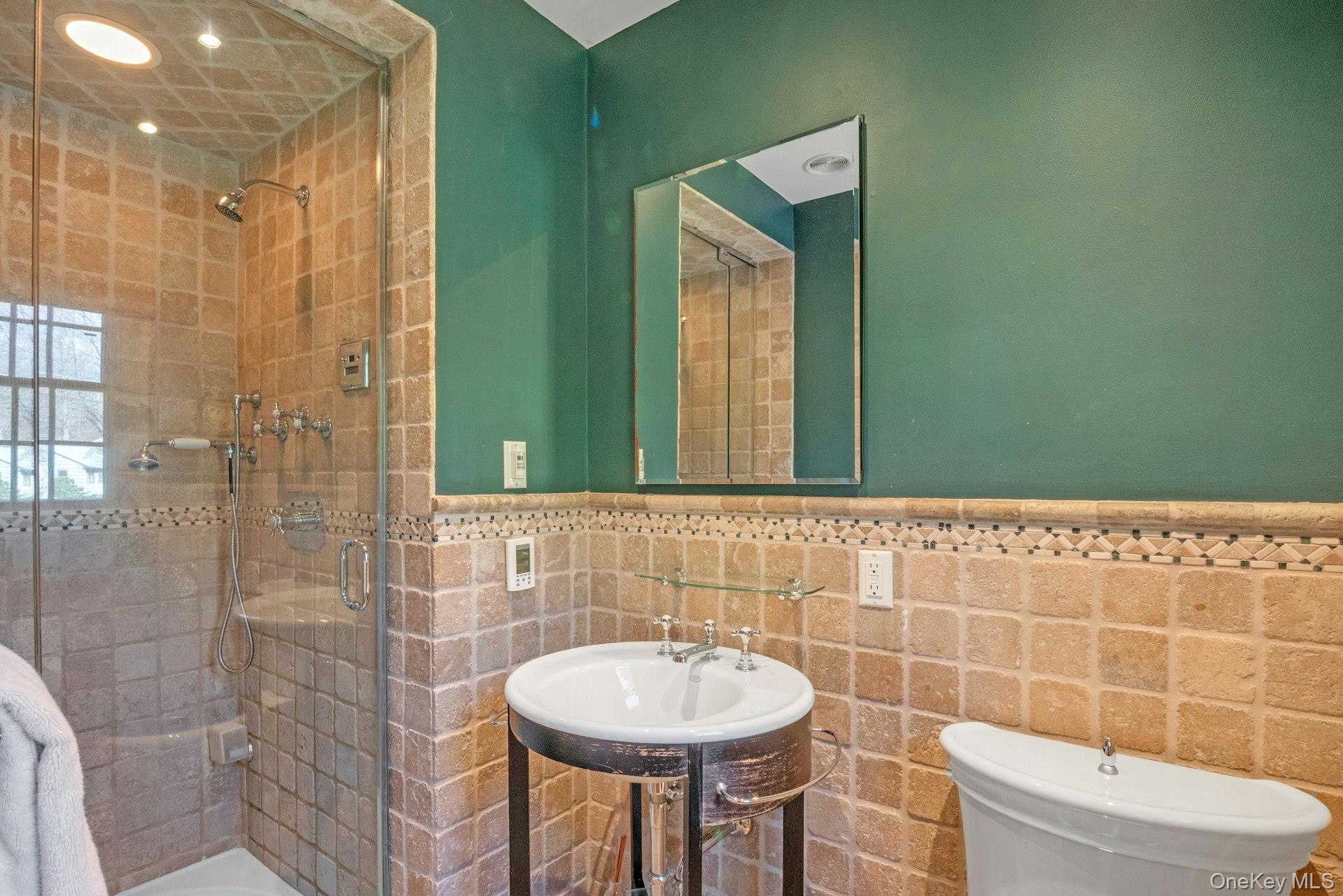 31 Orchard Road Briarcliff Manor, NY 10510 - Photo 10 of 33 a bathroom with a sink a toilet and a mirror