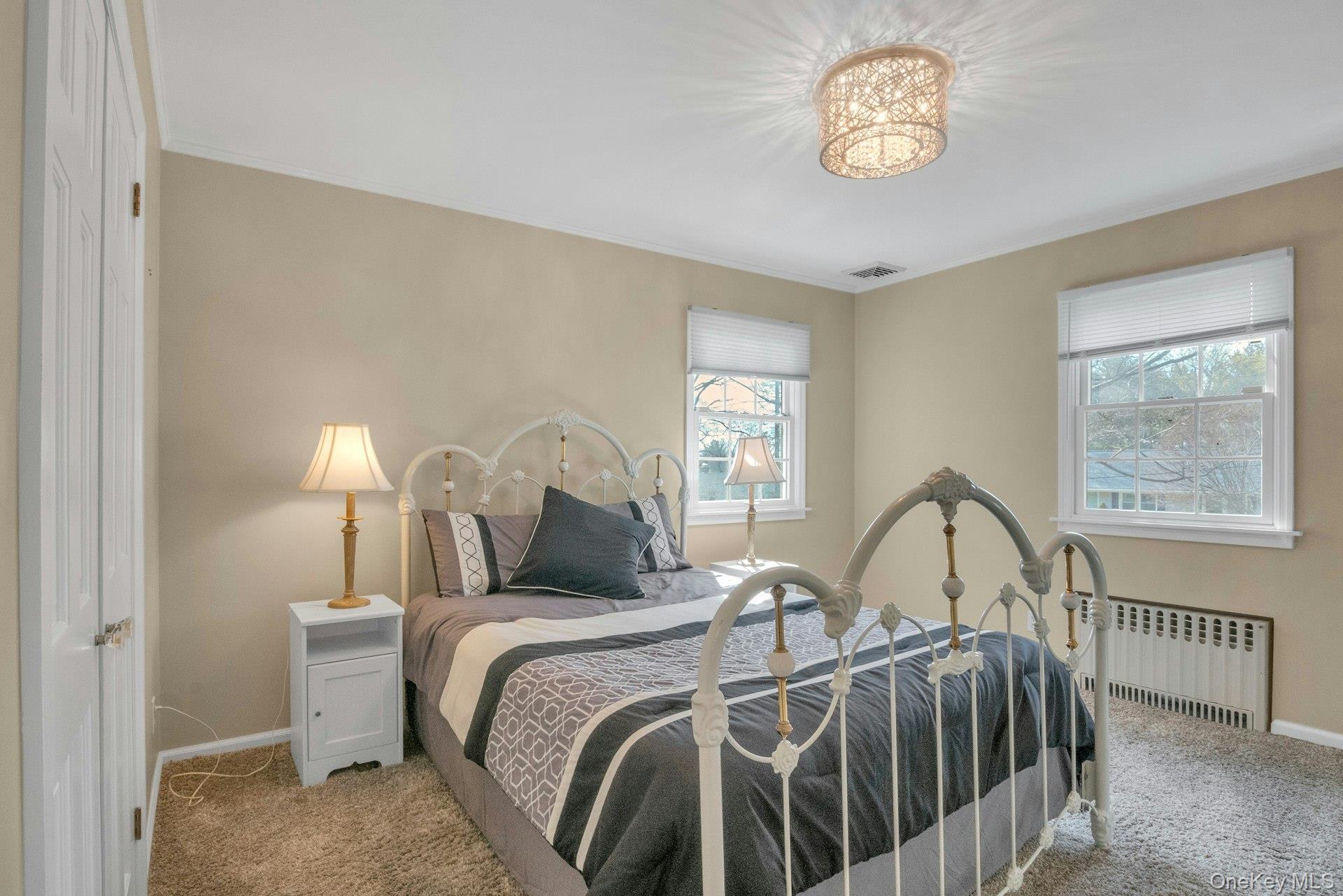 31 Orchard Road Briarcliff Manor, NY 10510 - Photo 11 of 33 a view of a bedroom with a bed and a chandelier