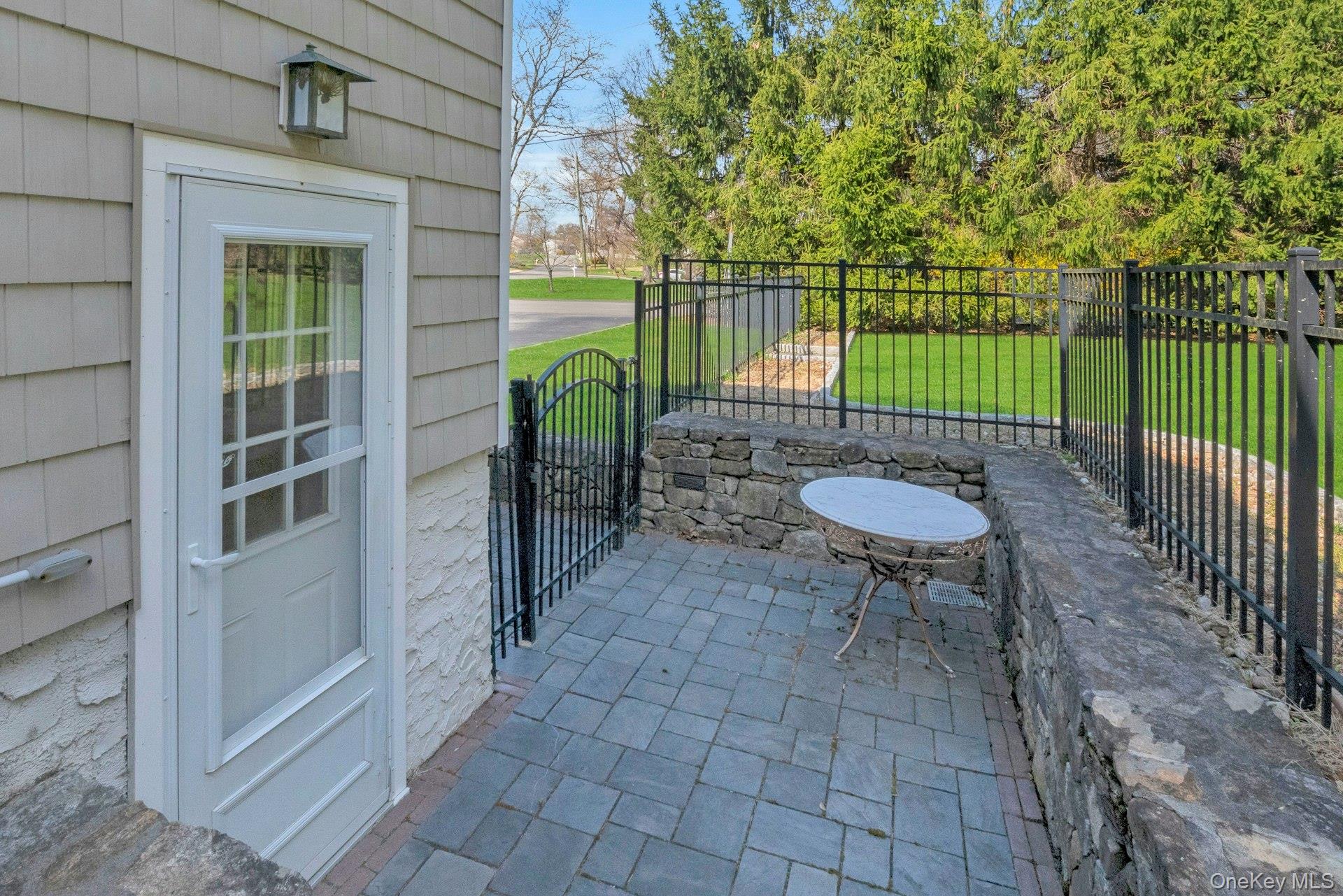 31 Orchard Road Briarcliff Manor, NY 10510 - Photo 21 of 33 a view of a chair and table in patio with wooden fence
