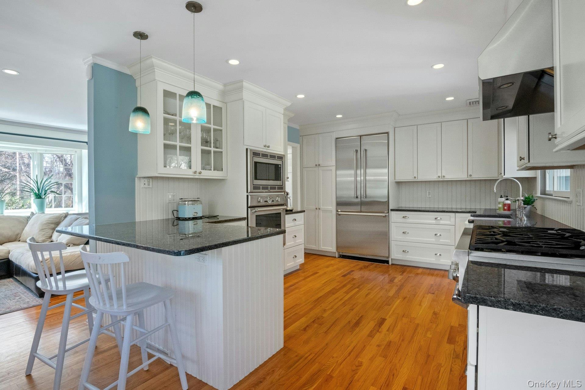 31 Orchard Road Briarcliff Manor, NY 10510 - Photo 5 of 33 a kitchen with granite countertop kitchen island stainless steel appliances a sink a stove a refrigerator and cabinets