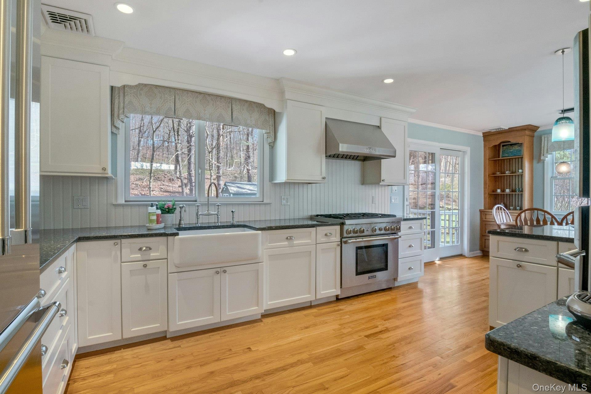 31 Orchard Road Briarcliff Manor, NY 10510 - Photo 7 of 33 a kitchen with stainless steel appliances granite countertop a stove and a sink