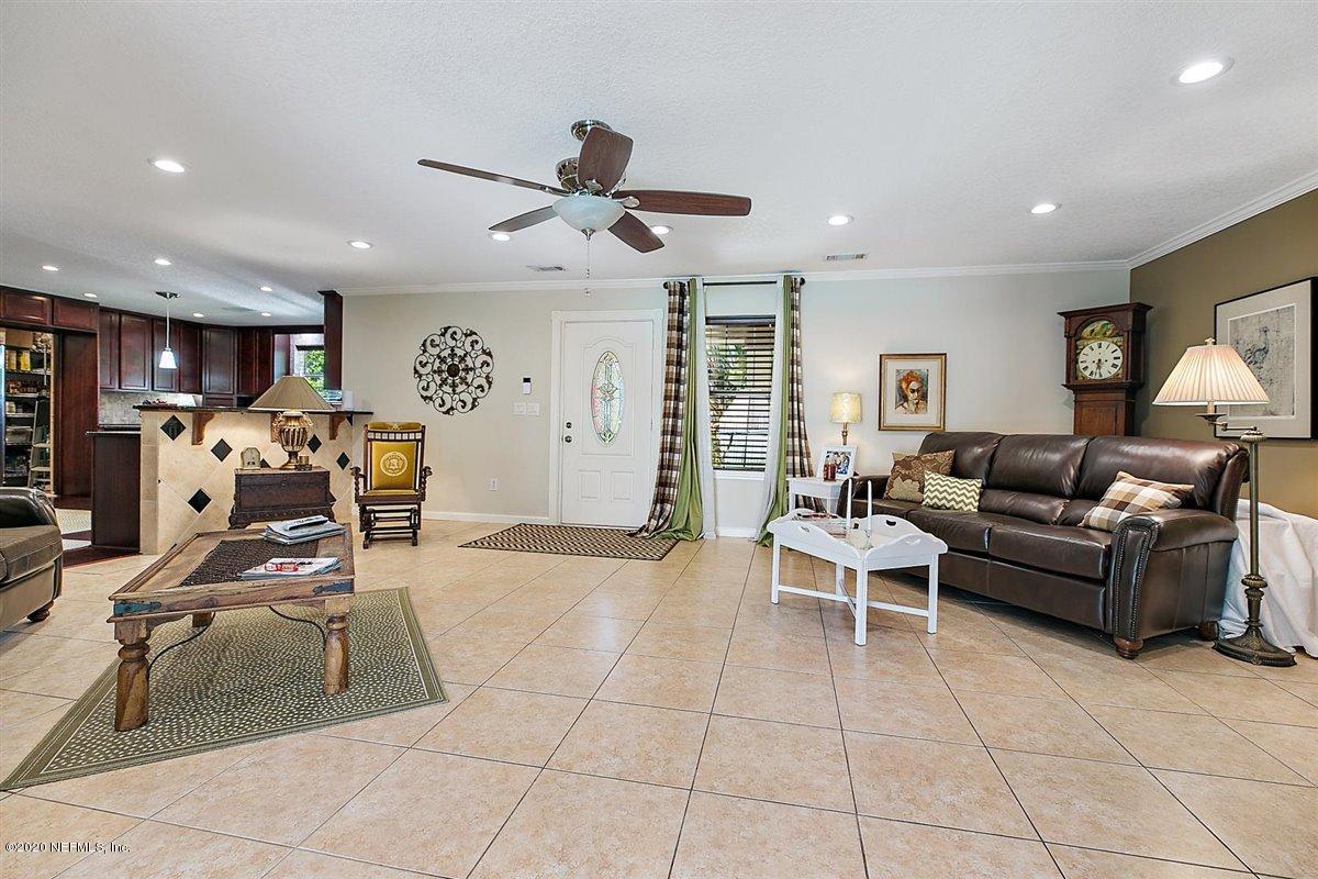 542188 Lem Turner Road Callahan, FL 32011 - Photo 3 of 34 a living room with furniture and a dining table with projector the kitchen