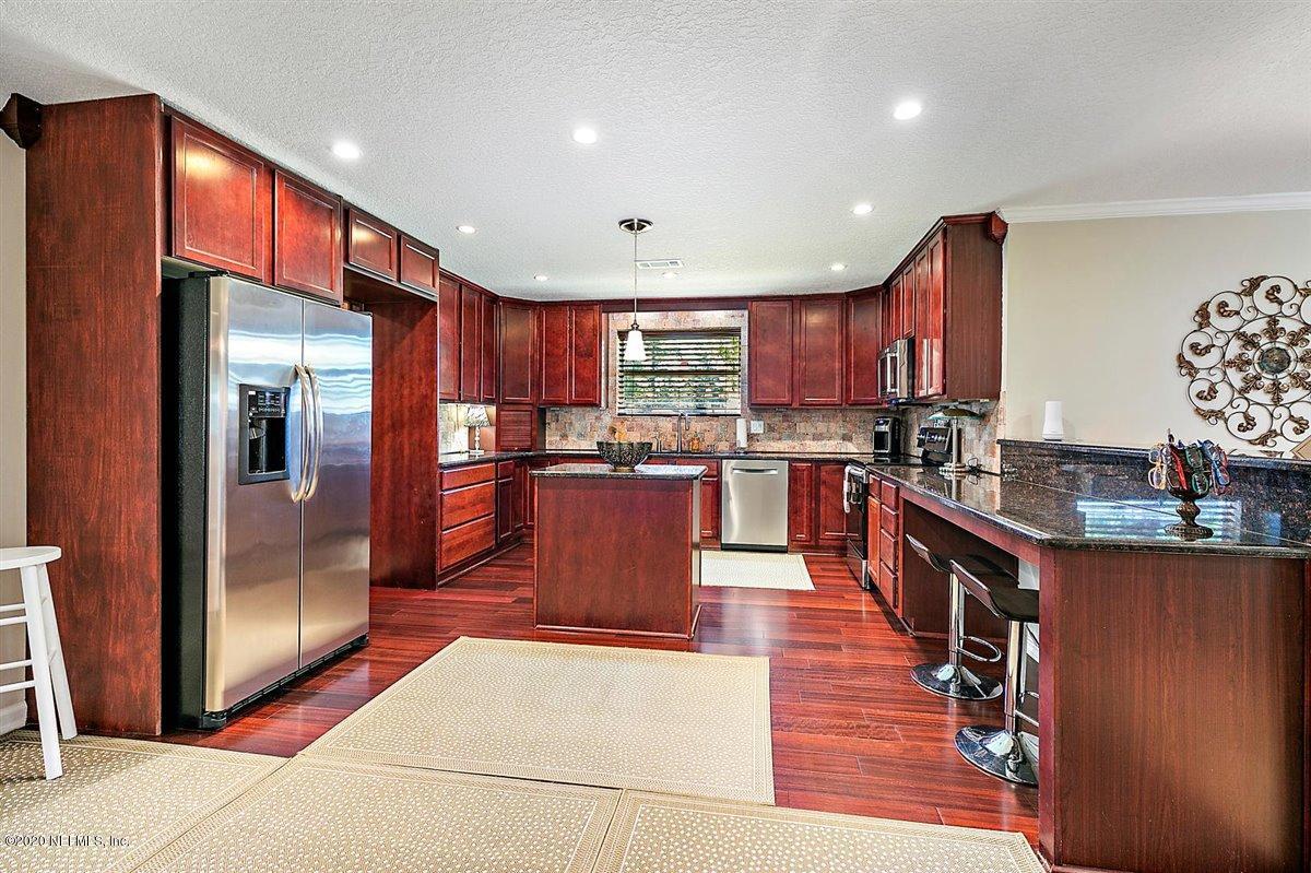 542188 Lem Turner Road Callahan, FL 32011 - Photo 8 of 34 a large kitchen with stainless steel appliances kitchen island granite countertop a large stove a refrigerator a sink and dishwasher