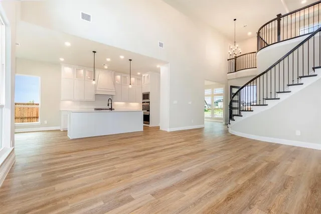 a view of kitchen and hall with wooden floor