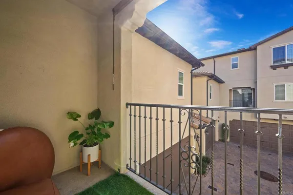 a balcony with potted plants and wooden fence