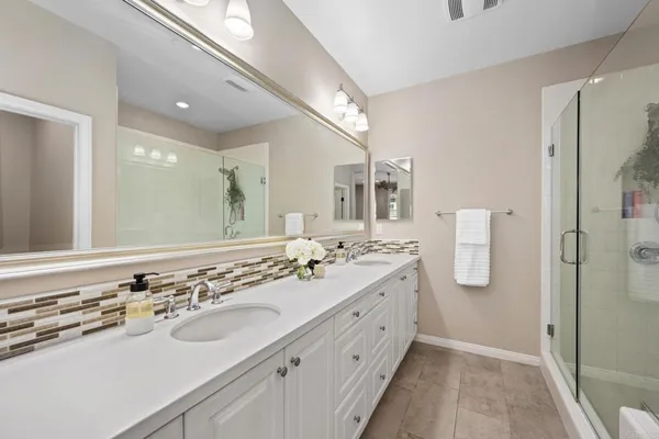 a bathroom with a sink double vanity and a mirror