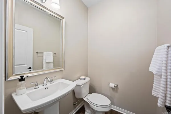a bathroom with a sink a toilet and mirror