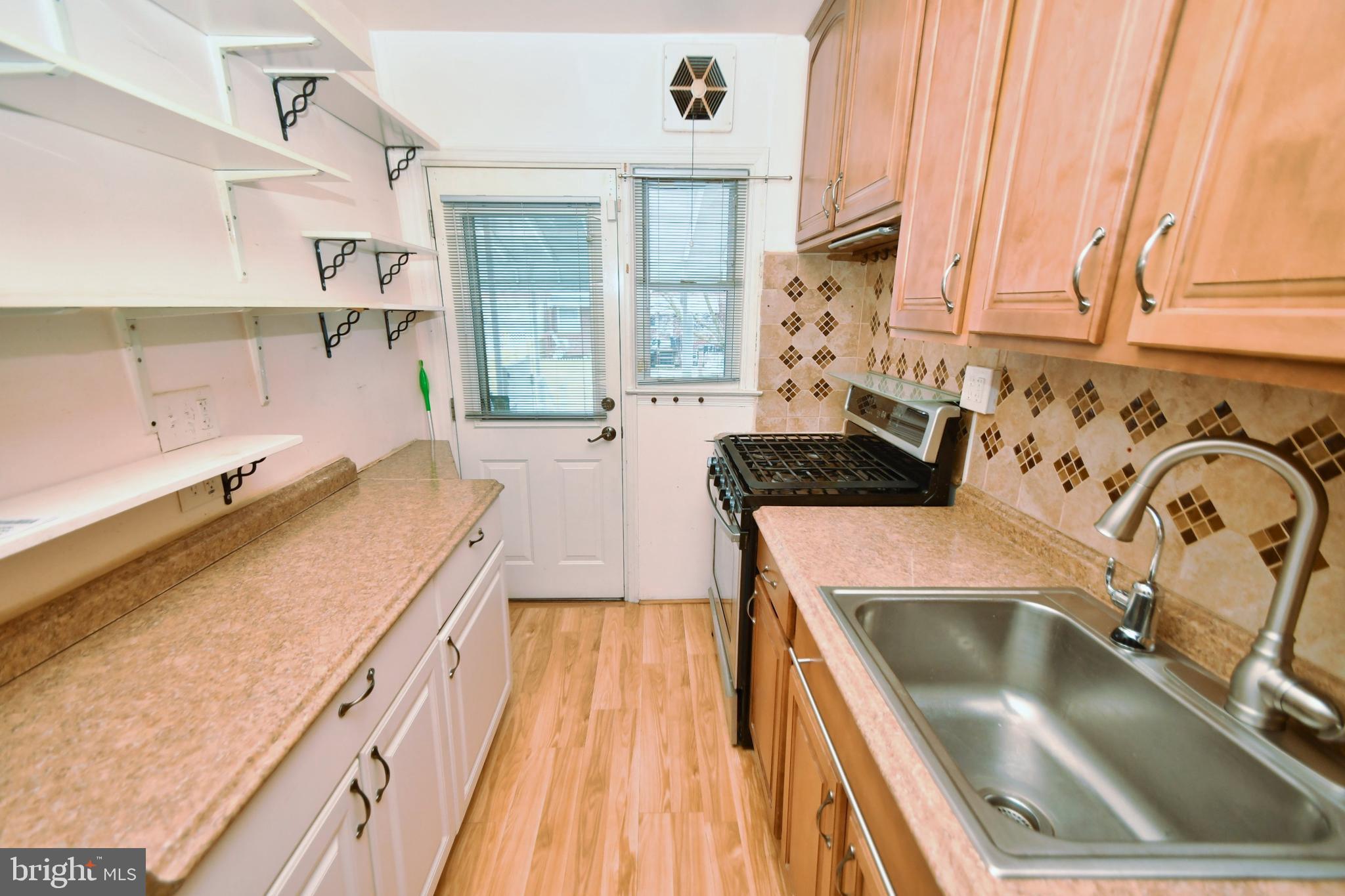 1041 Arncliffe Road Baltimore, MD 21221 - Photo 9 of 40 a kitchen with a sink and a stove top oven