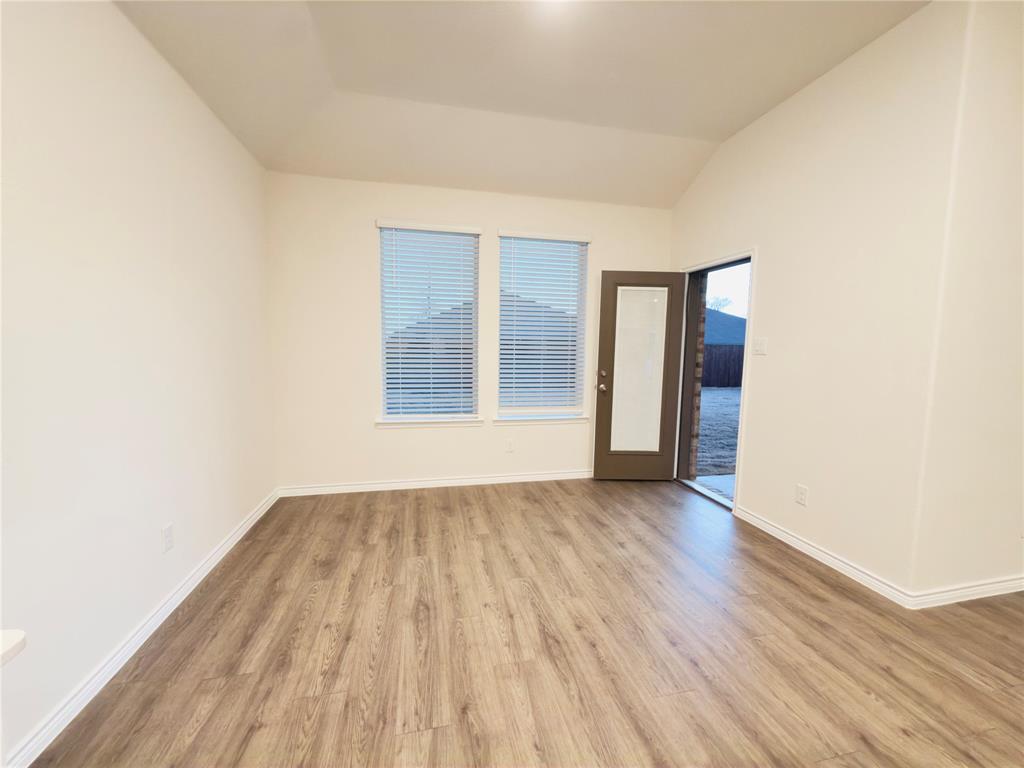 2117 Eugene Street Anna, TX 75409 - Photo 14 of 31 Empty room featuring light wood finished floors and vaulted ceiling
