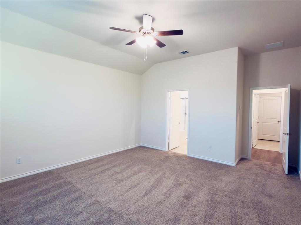 2117 Eugene Street Anna, TX 75409 - Photo 15 of 31 Unfurnished bedroom featuring dark carpet, a ceiling fan, and lofted ceiling