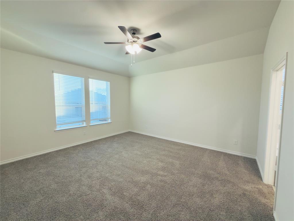 2117 Eugene Street Anna, TX 75409 - Photo 18 of 31 Unfurnished room featuring carpet floors, lofted ceiling, and a ceiling fan