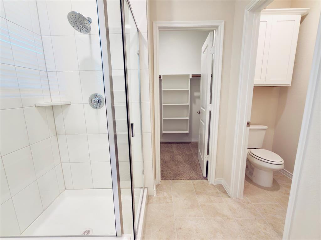 2117 Eugene Street Anna, TX 75409 - Photo 21 of 31 Bathroom featuring a walk in closet and a stall shower