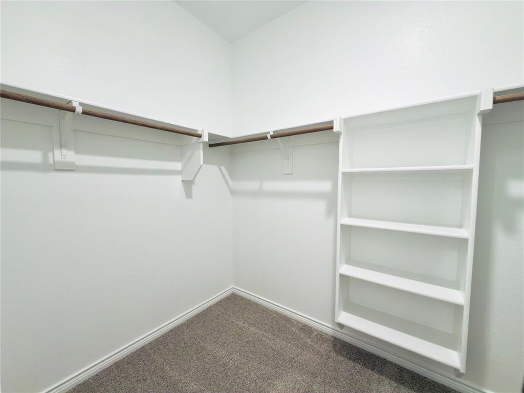 2117 Eugene Street Anna, TX 75409 - Photo 23 of 31 Walk in closet featuring dark carpet