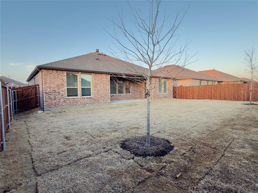 2117 Eugene Street Anna, TX 75409 - Photo 25 of 31 Rear view of property featuring a fenced backyard, brick siding, a patio area, a gate, and roof with shingles