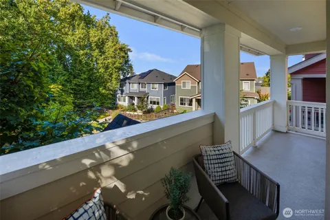 a view of a house with pool and chairs