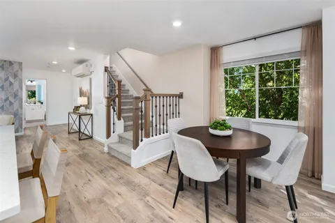 a dining room with furniture and wooden floor