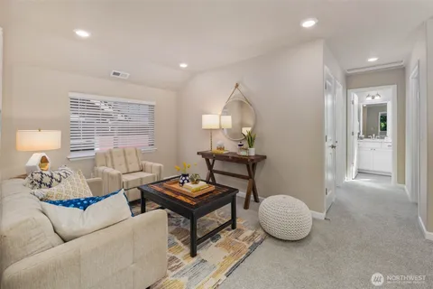 a living room with furniture a window and a table