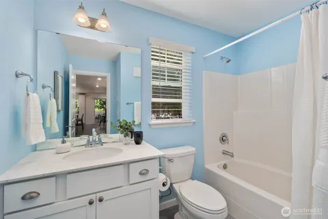 a bathroom with a sink toilet a mirror and shower