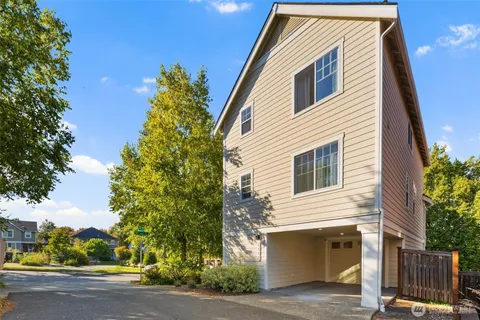a front view of a house with a tree