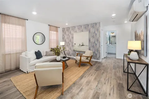 a living room with furniture and a wooden floor