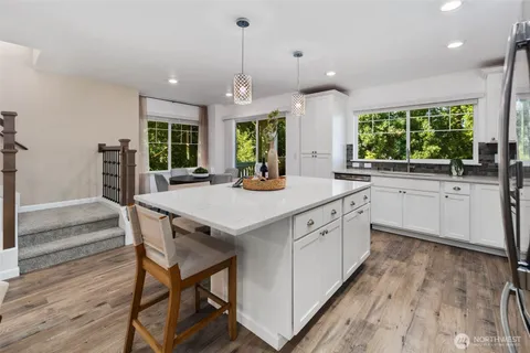 a kitchen with a table chairs sink and cabinets