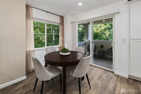 a view of a dining room with furniture window and wooden floor