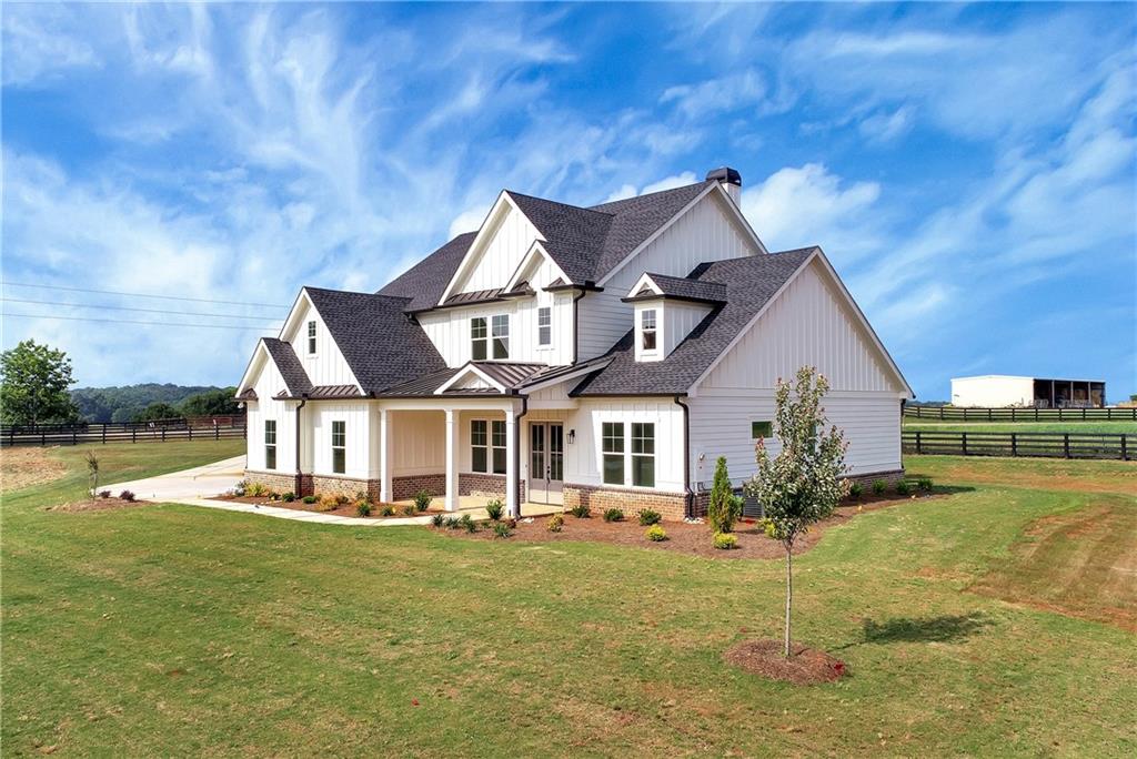 72 Murphy Road Pendergrass, GA 30567 - Photo 1 of 1 a front view of a house with a yard table and chairs
