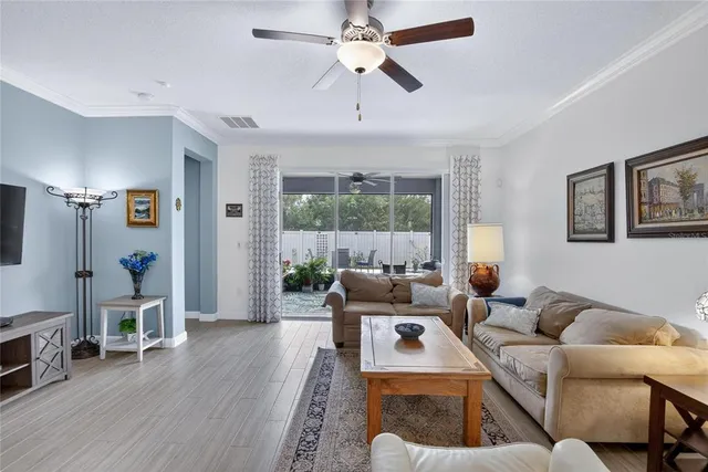 a bedroom with a bed wooden floor and window