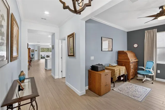 a bedroom with a bed a dresser and a flat screen tv