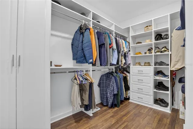 a storage room with cabinets and wooden floor