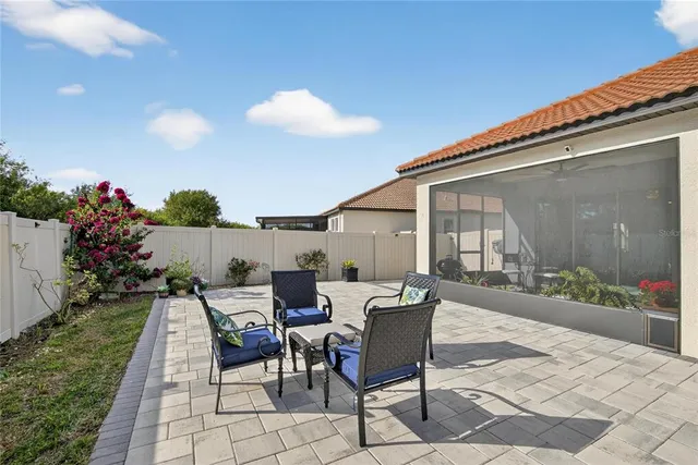 an aerial view of a brick building with many windows and yard