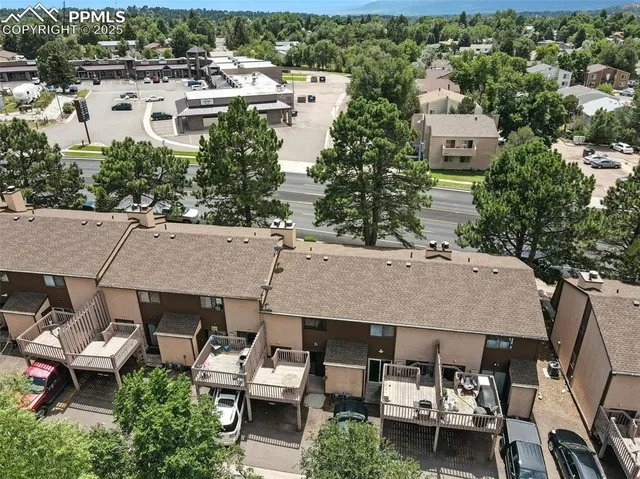 an aerial view of a house with swimming pool and outdoor seating