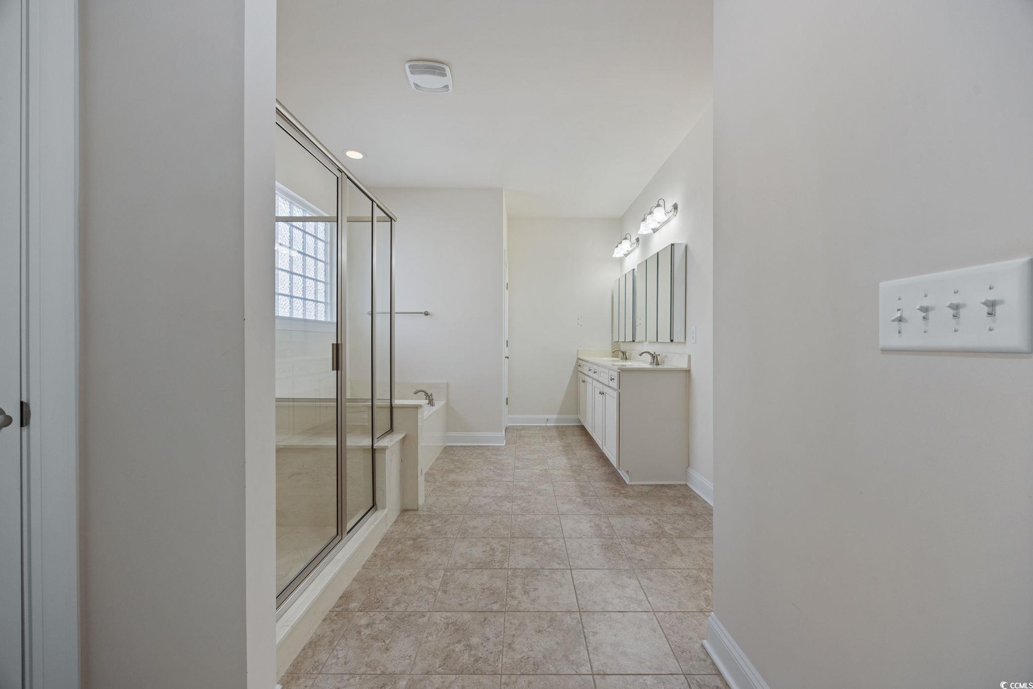 1900 Bluff Drive Myrtle Beach, SC 29577 - Photo 13 of 38 Bathroom featuring a garden tub, vanity, a shower stall, light tile patterned floors, and recessed lighting