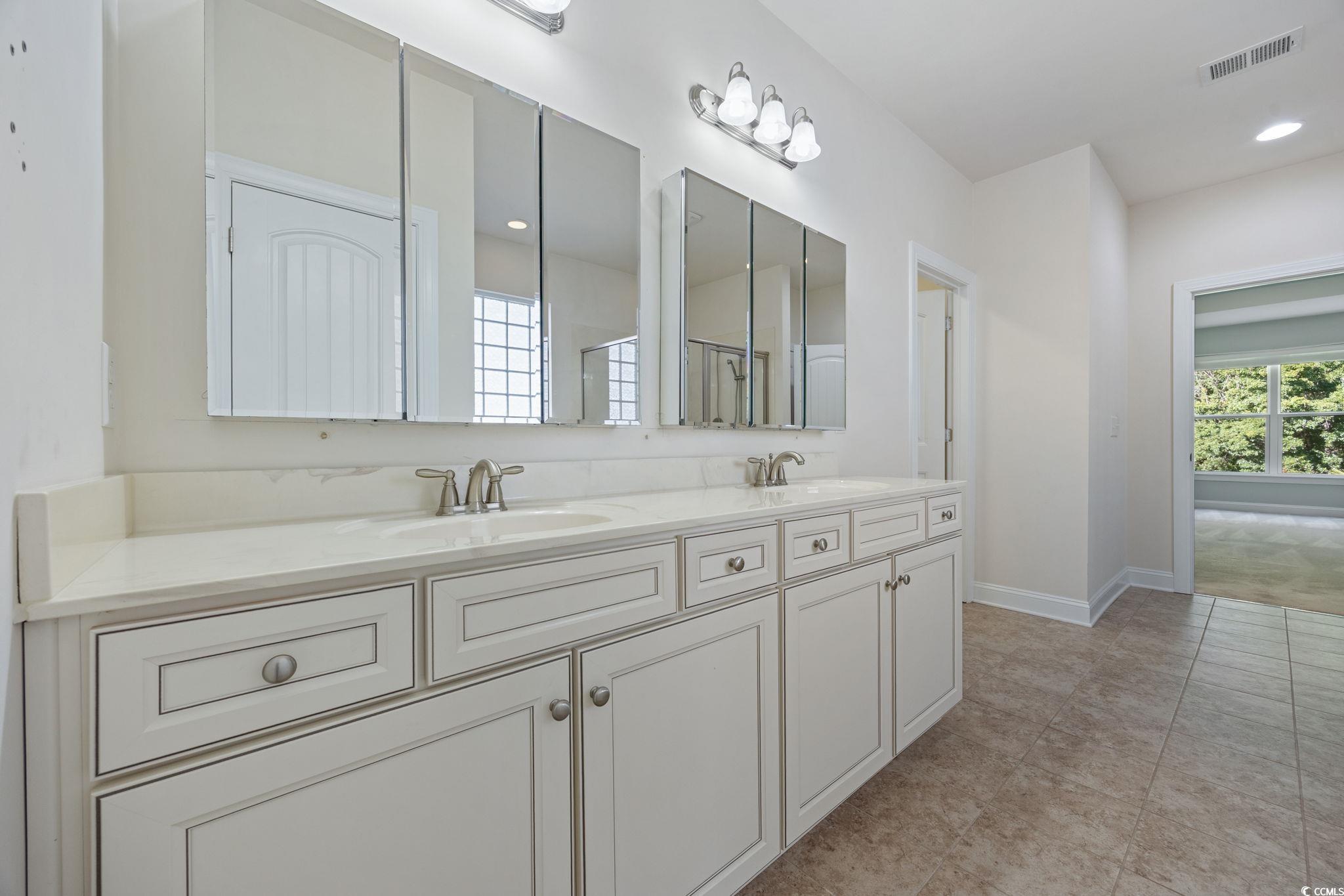 1900 Bluff Drive Myrtle Beach, SC 29577 - Photo 14 of 38 Full bathroom with double vanity, a shower, and recessed lighting