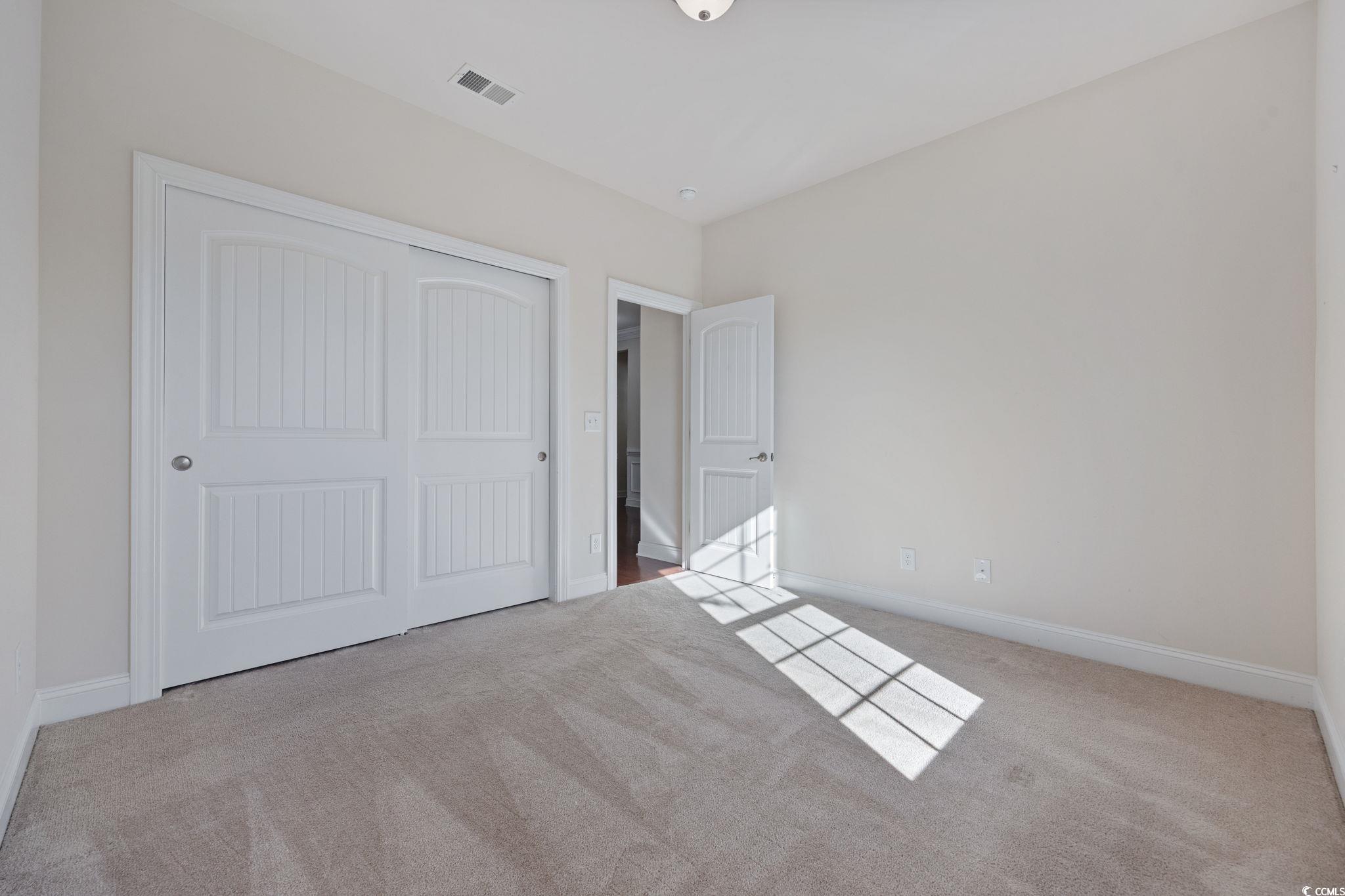 1900 Bluff Drive Myrtle Beach, SC 29577 - Photo 18 of 38 Unfurnished bedroom with light carpet and a closet