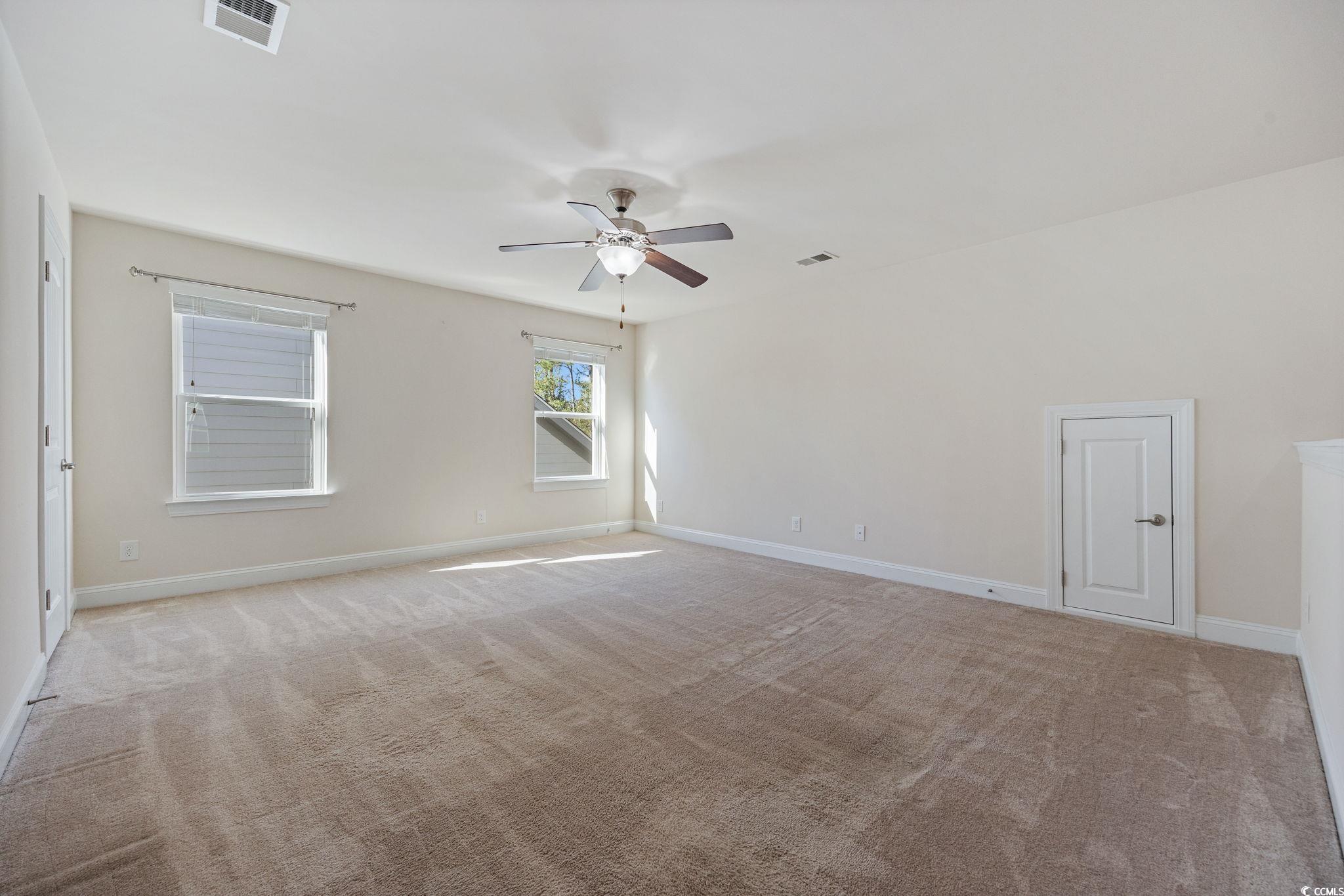 1900 Bluff Drive Myrtle Beach, SC 29577 - Photo 20 of 38 Empty room featuring light carpet and ceiling fan