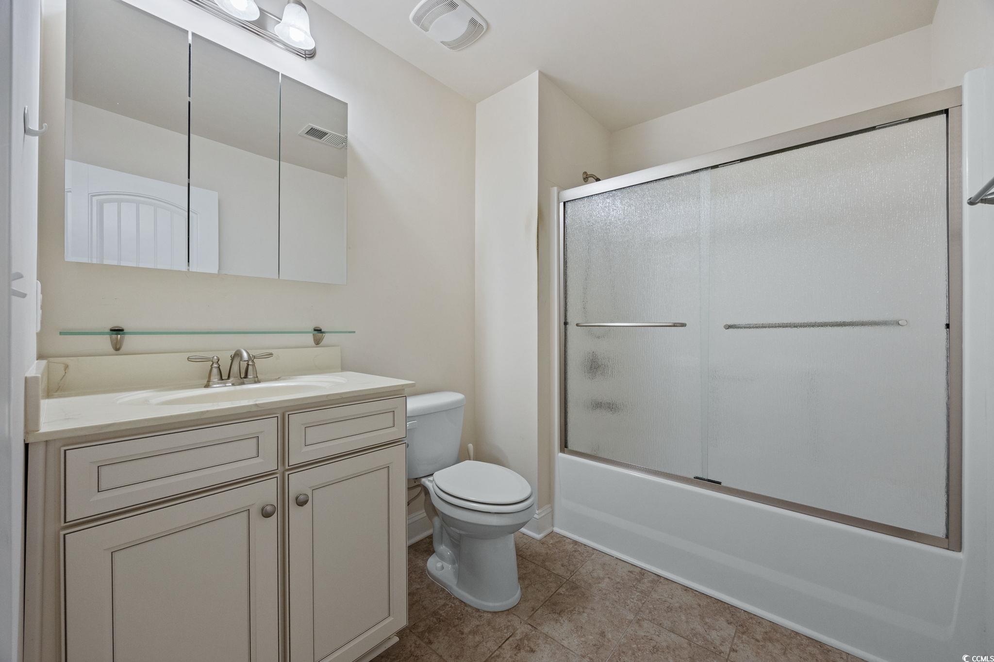 1900 Bluff Drive Myrtle Beach, SC 29577 - Photo 24 of 38 Full bath with vanity, combined bath / shower with glass door, and light tile patterned floors