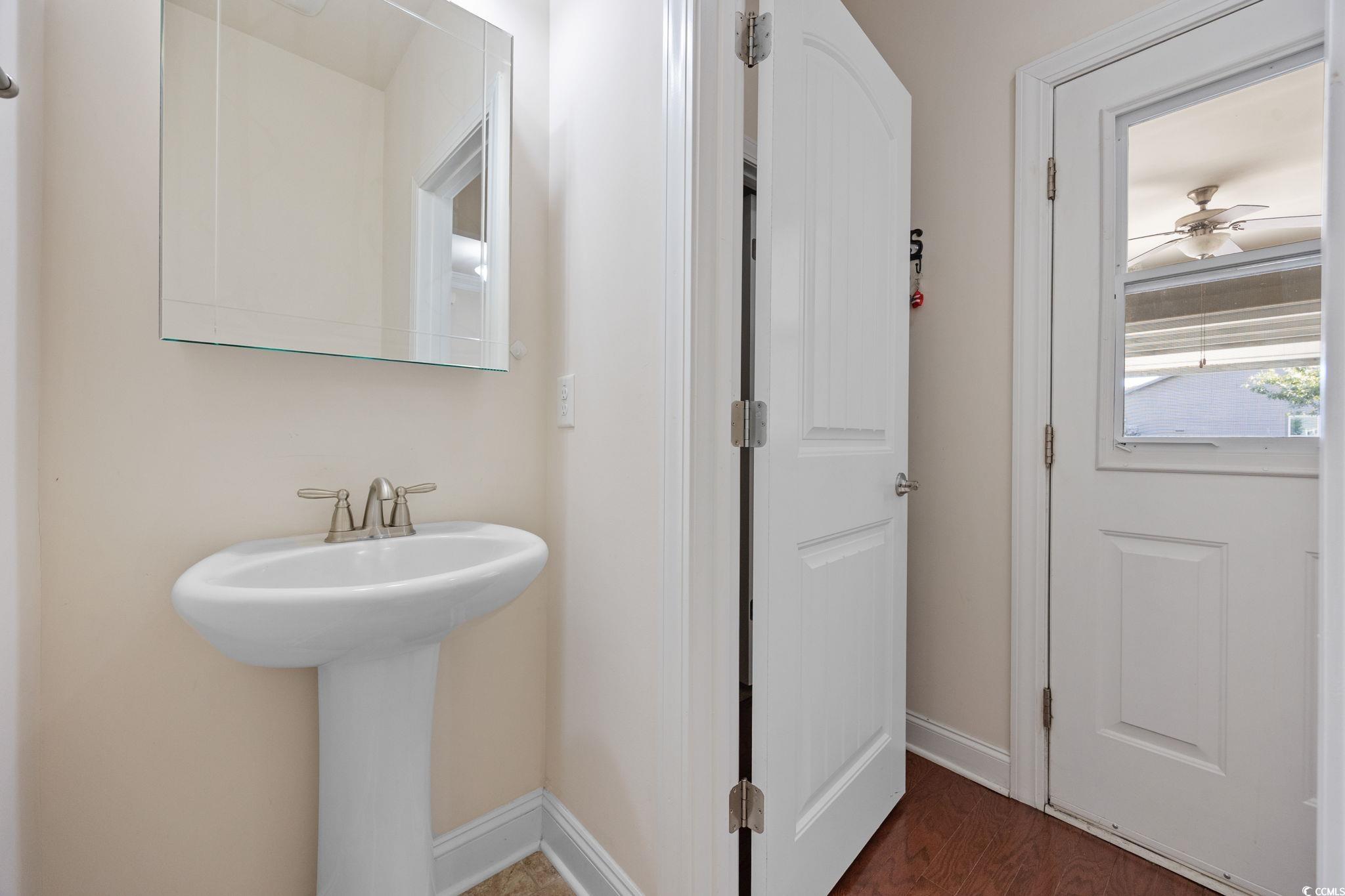1900 Bluff Drive Myrtle Beach, SC 29577 - Photo 25 of 38 Bathroom with dark wood finished floors and ceiling fan