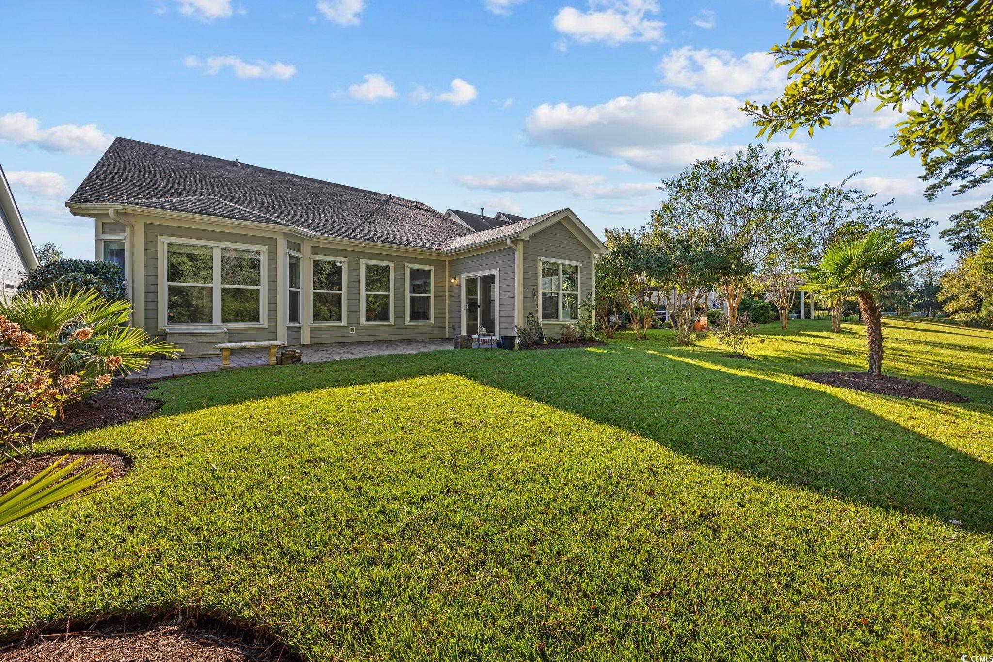 1900 Bluff Drive Myrtle Beach, SC 29577 - Photo 28 of 38 Rear view of house featuring a lawn and a patio area