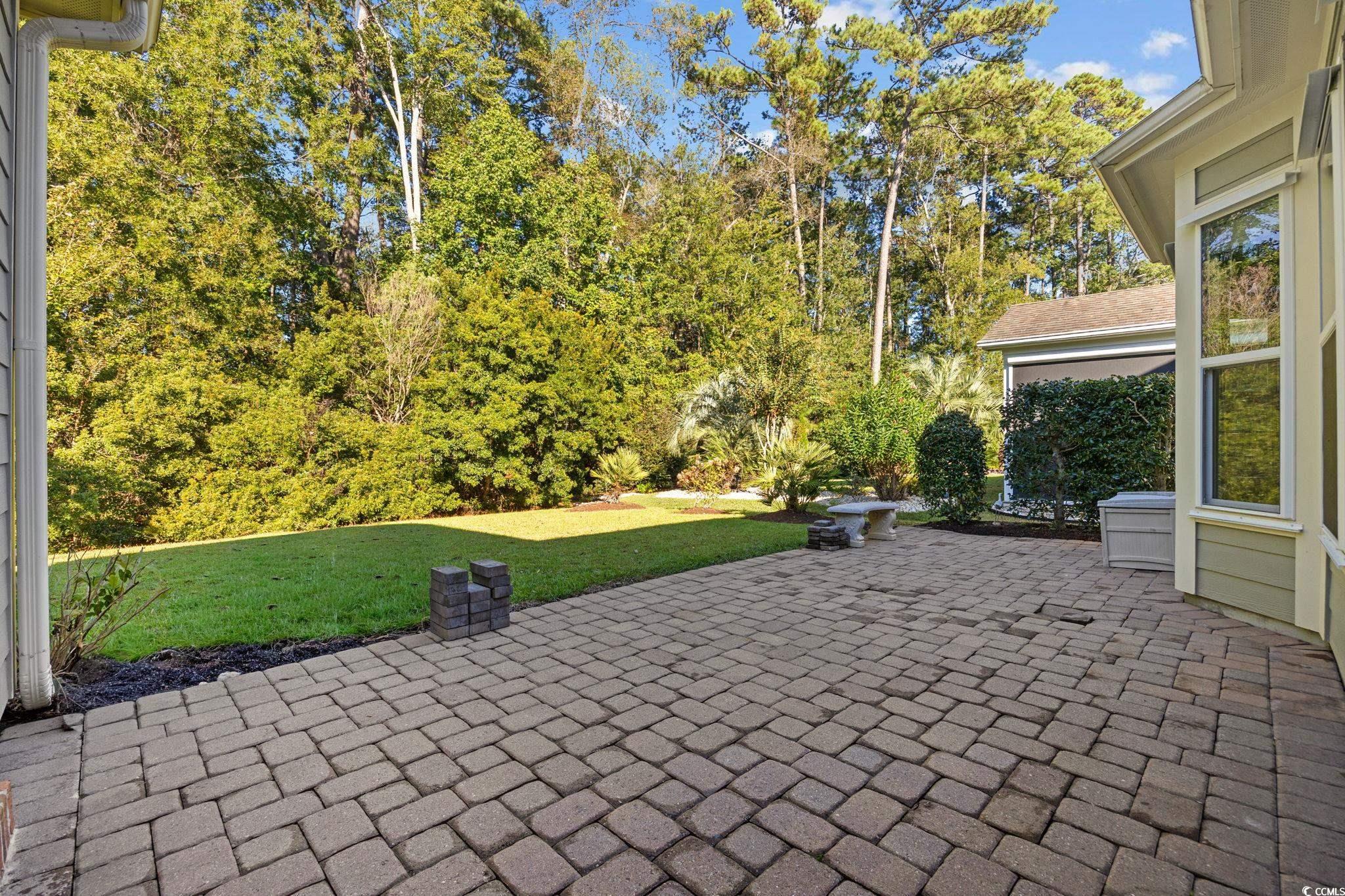 1900 Bluff Drive Myrtle Beach, SC 29577 - Photo 29 of 38 View of patio / terrace featuring view of wooded area