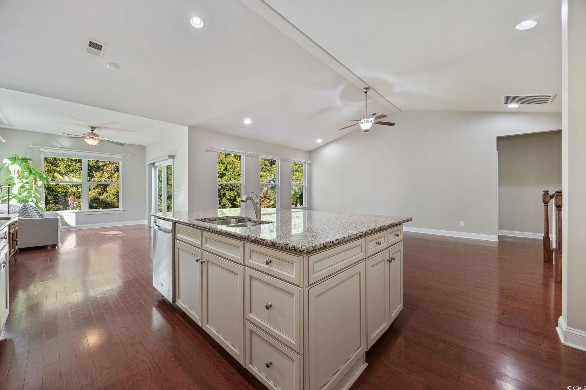 1900 Bluff Drive Myrtle Beach, SC 29577 - Photo 37 of 38 Kitchen featuring ceiling fan, recessed lighting, light stone counters, open floor plan, and dark wood-type flooring