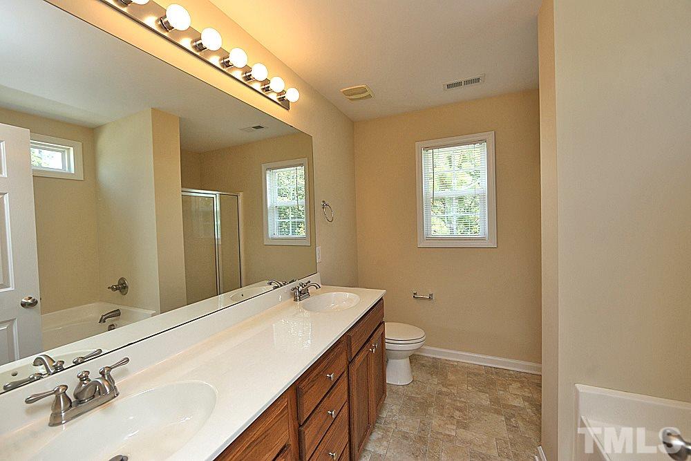 2014 Lime Street Durham, NC 27704 - Photo 13 of 17 a bathroom with a double vanity sink and a mirror