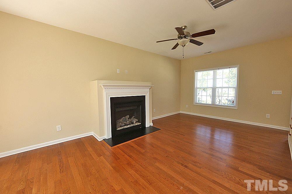 2014 Lime Street Durham, NC 27704 - Photo 4 of 17 a view of empty room with wooden floor fireplace and windows