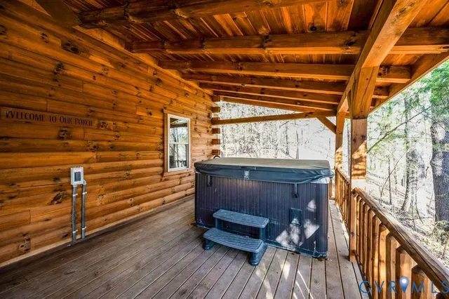 a view of a backyard with table and chairs potted plants and large tree