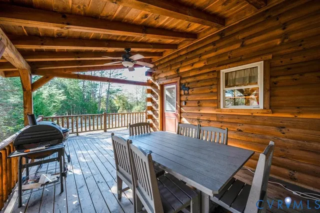 a view of a backyard with table and chairs under an umbrella