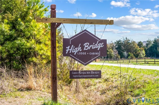 a view of a pathway of a house and a small yard and wooden fence