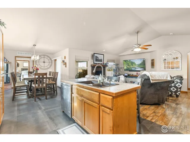 a kitchen with kitchen island granite countertop lots of counter top space and painting on the wall
